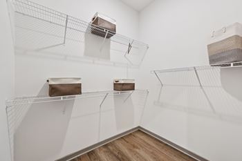 A white room with shelves and boxes on them.